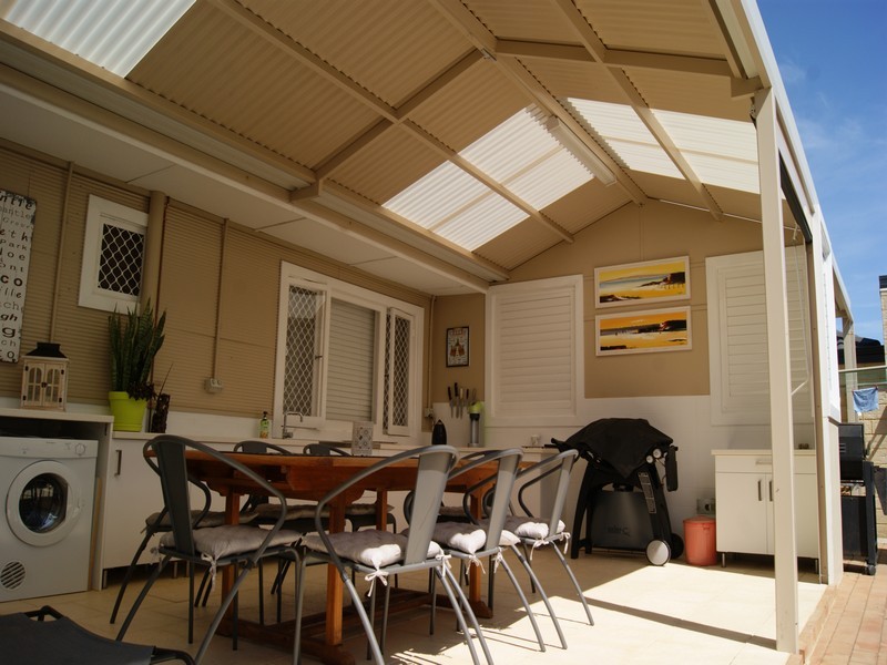 outdoor kitchen under a gable patio by great aussie patios