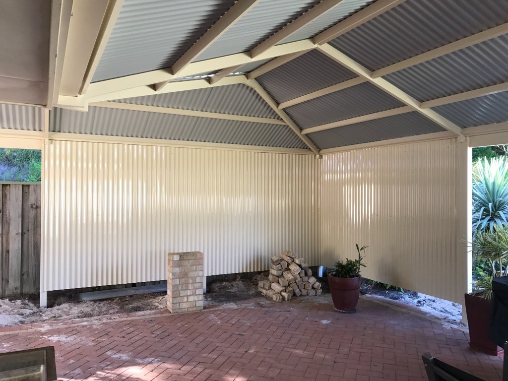 Utilising decorative screens to enclose a patio.