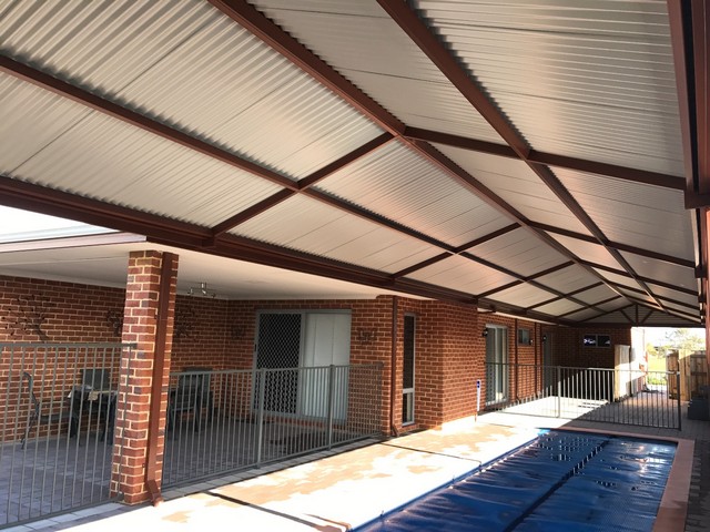 The underside of a COLORBOND patio roof above a home swimming pool.